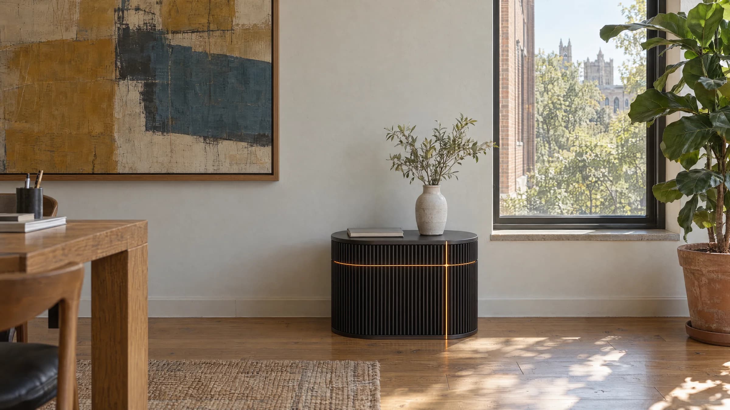 Wick in graphite, in an office with an oak desk and a large abstract painting.